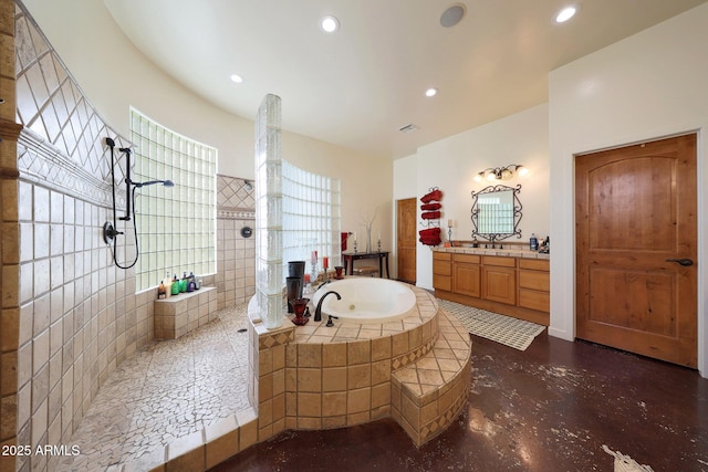 bathroom featuring vanity and independent shower and bath