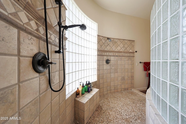 bathroom featuring a tile shower