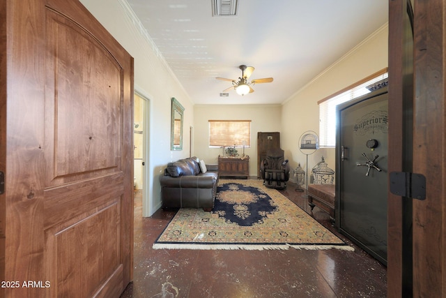 living room with ceiling fan and ornamental molding