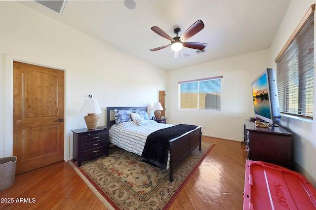 bedroom with lofted ceiling, hardwood / wood-style floors, and ceiling fan