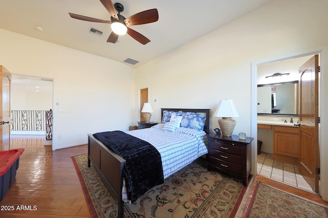 bedroom featuring sink, ensuite bath, ceiling fan, dark hardwood / wood-style flooring, and vaulted ceiling