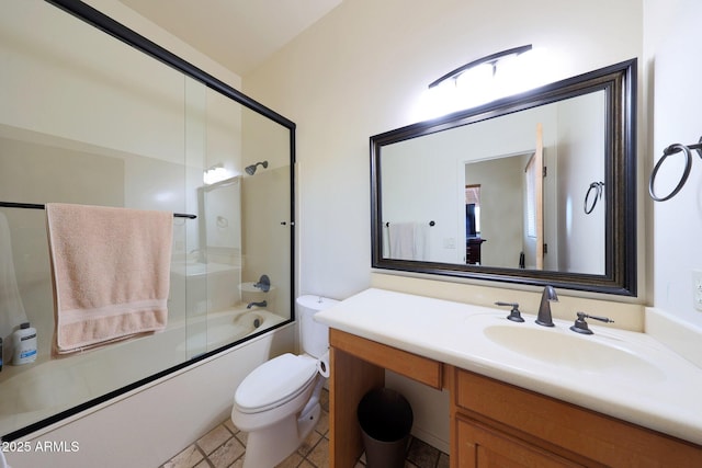 full bathroom with vanity, bath / shower combo with glass door, and toilet