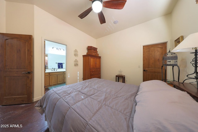 bedroom featuring ceiling fan, lofted ceiling, sink, and ensuite bath