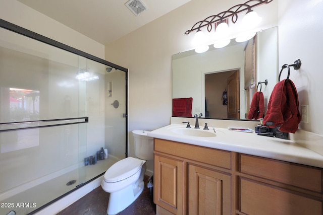 bathroom with vanity, toilet, and a shower with shower door