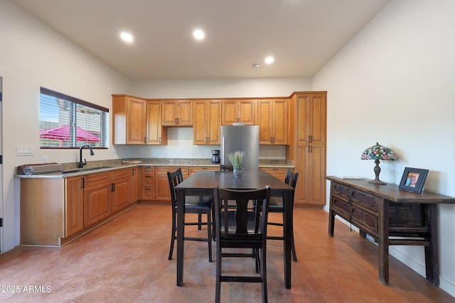 kitchen featuring stainless steel refrigerator and sink