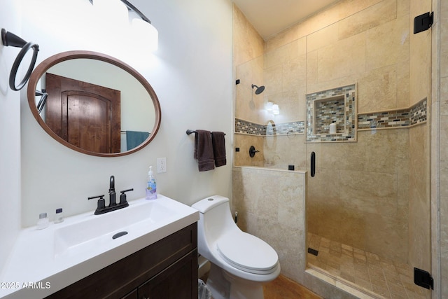 bathroom featuring vanity, toilet, and an enclosed shower