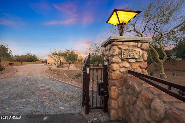 view of gate at dusk