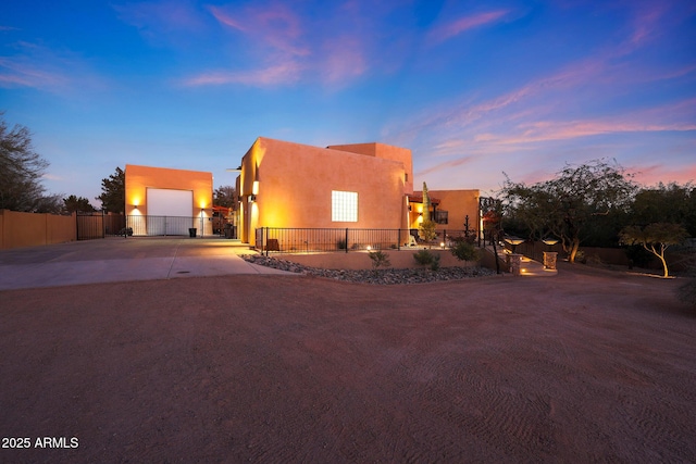 pueblo revival-style home with a garage