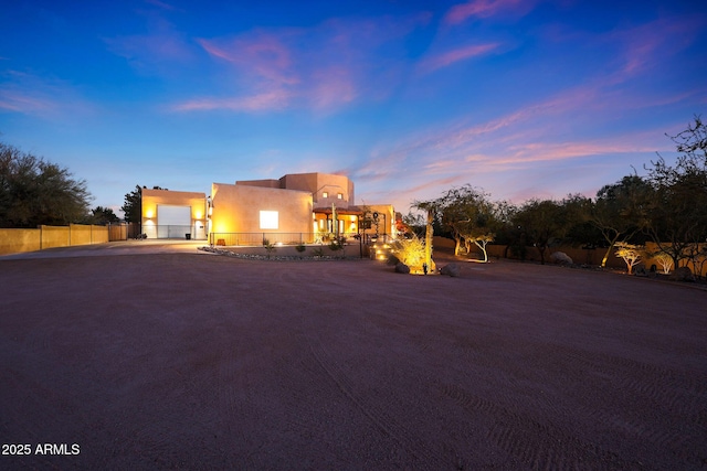 pueblo-style house featuring a garage