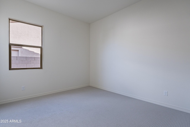 unfurnished room featuring carpet floors and baseboards