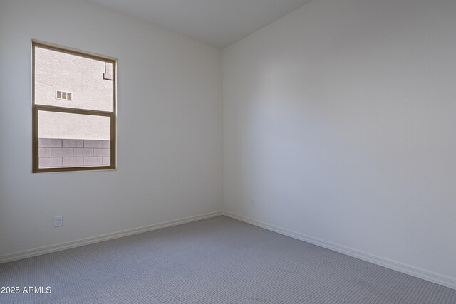 unfurnished room featuring baseboards, visible vents, and carpet floors