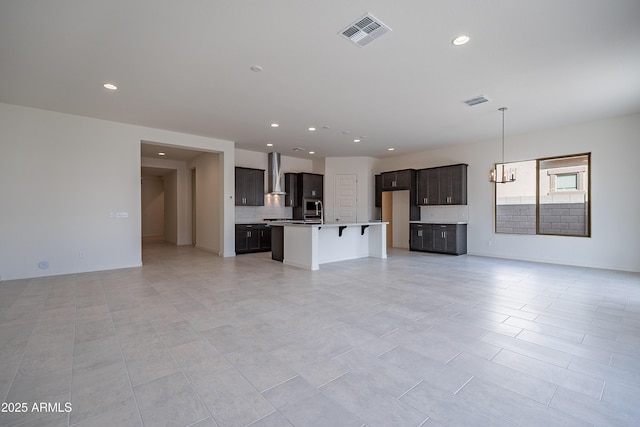 unfurnished living room featuring light tile patterned floors, recessed lighting, and visible vents