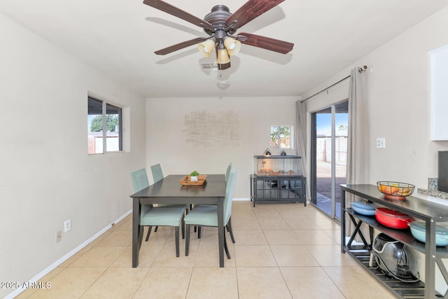 tiled dining space with ceiling fan and a healthy amount of sunlight