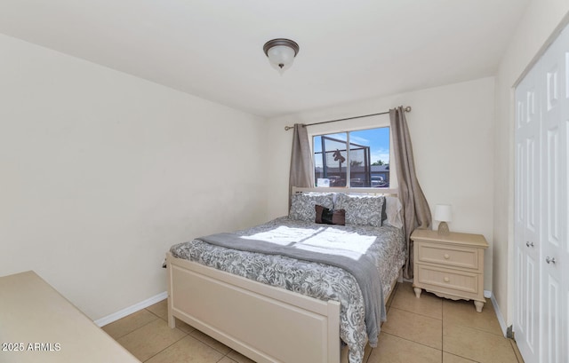 tiled bedroom featuring a closet