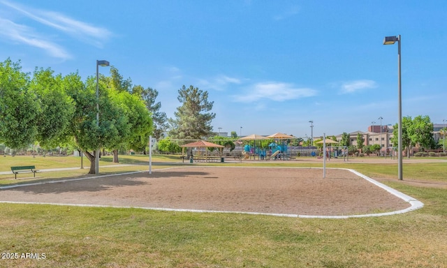 view of property's community featuring a gazebo, a playground, and a lawn