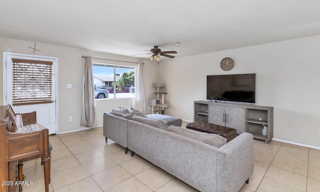 living room featuring a wealth of natural light, light tile patterned floors, and ceiling fan