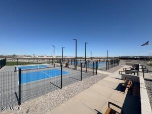 view of pool featuring a tennis court and fence