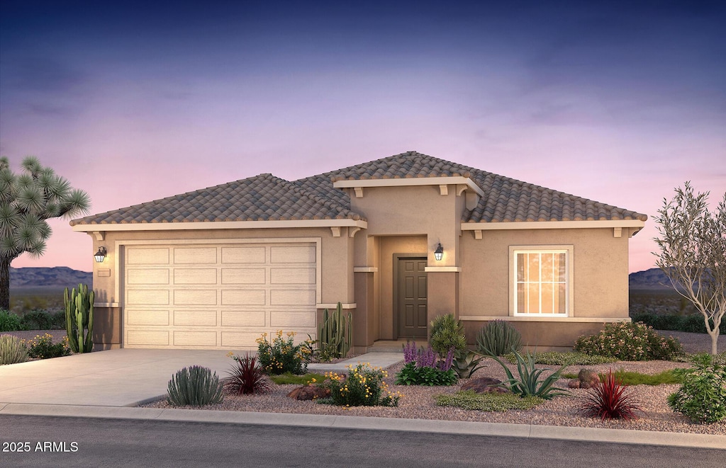 view of front of house with driveway, stucco siding, a garage, and a tiled roof