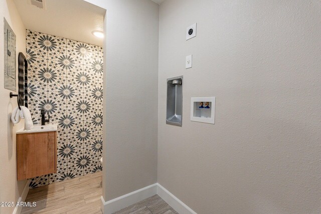 1005 N Granite Reef Rd, Scottsdale, AZ 85257 - laundry area with hookup for a washing machine, electric dryer hookup, and light wood finished floors