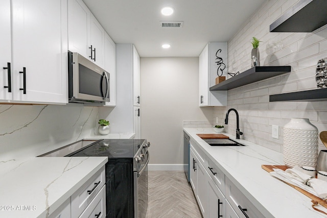 1005 N Granite Reef Rd, Scottsdale, AZ 85257 - kitchen featuring stainless steel appliances, open shelves, tasteful backsplash, white cabinetry, and recessed lighting