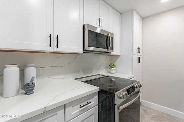 1005 N Granite Reef Rd, Scottsdale, AZ 85257 - kitchen with appliances with stainless steel finishes, white cabinets, and light stone countertops