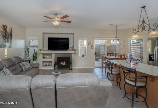 tiled living room featuring ceiling fan