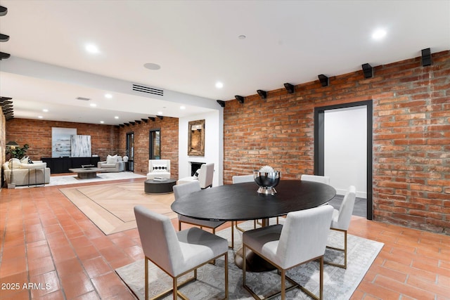 dining area featuring brick wall