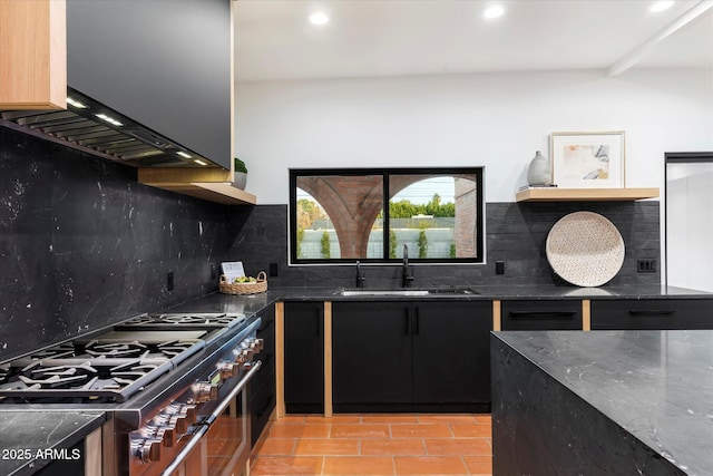 kitchen with light tile patterned flooring, sink, high end range, ventilation hood, and backsplash