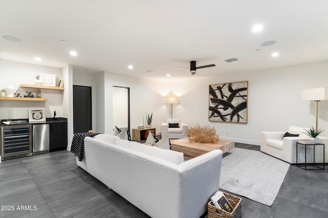 living room featuring wine cooler, ceiling fan, and indoor wet bar