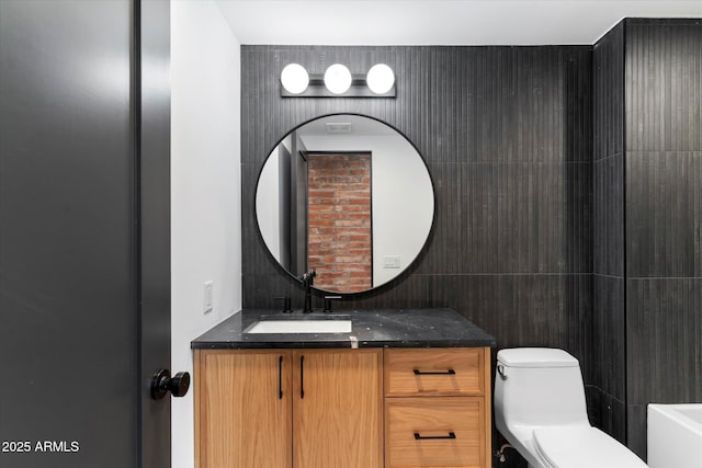 bathroom featuring vanity and toilet