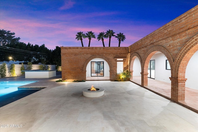 patio terrace at dusk with a fire pit