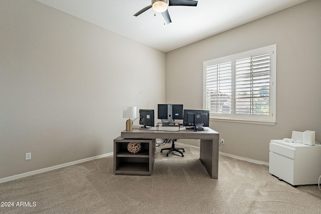 carpeted office space with ceiling fan