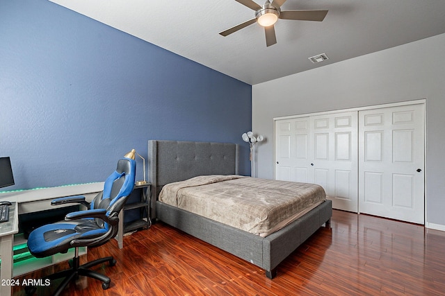 bedroom featuring vaulted ceiling, ceiling fan, a closet, and dark hardwood / wood-style flooring