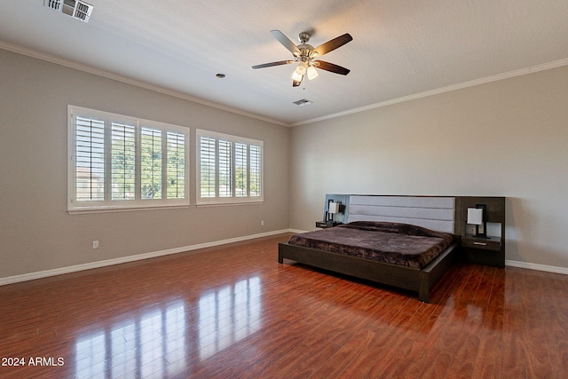 bedroom with dark wood-type flooring, ceiling fan, a textured ceiling, and crown molding