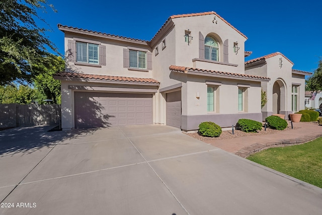 1912 E Gemini Pl, Chandler, AZ 85249 - mediterranean / spanish-style home featuring an attached garage, stucco siding, a tiled roof, and concrete driveway