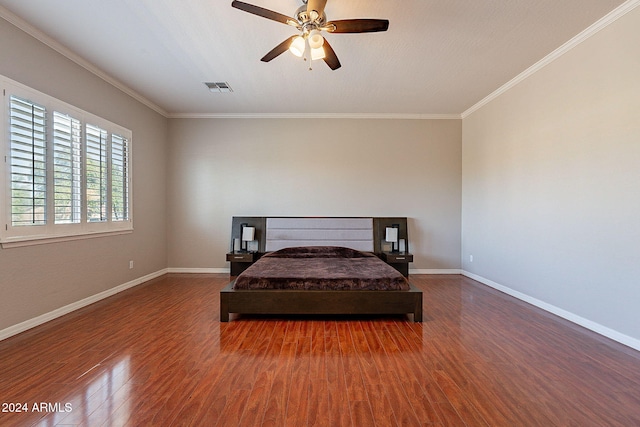 bedroom featuring hardwood / wood-style floors, ceiling fan, and crown molding