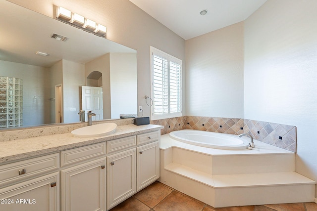 bathroom featuring a tub, tile patterned flooring, and vanity