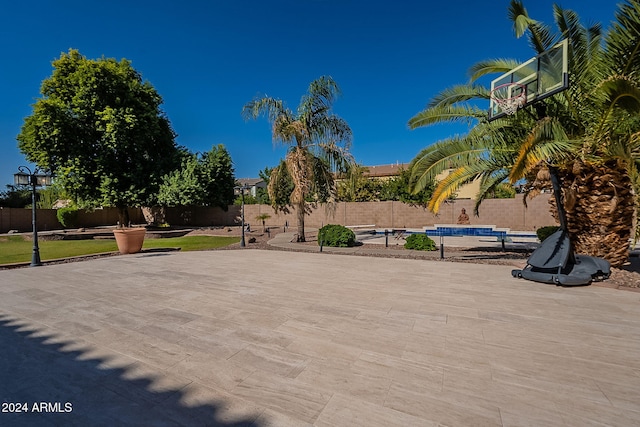 view of basketball court featuring a swimming pool