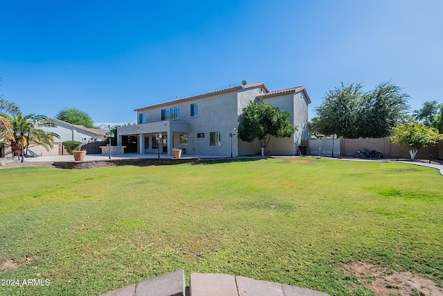 rear view of house with a yard, a patio, and a pergola