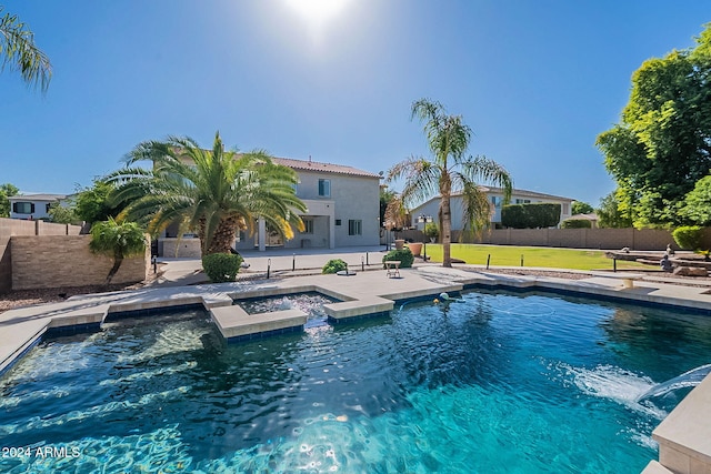 view of swimming pool with a patio, a yard, and an in ground hot tub