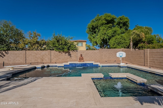 view of swimming pool with a patio, an in ground hot tub, and pool water feature