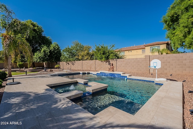 view of swimming pool with pool water feature and an in ground hot tub