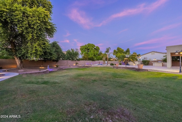 yard at dusk with a patio