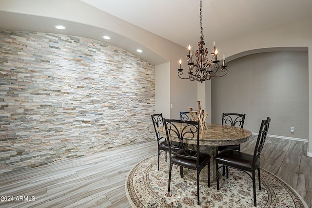 dining room featuring light hardwood / wood-style flooring and an inviting chandelier