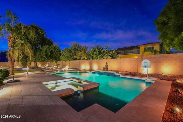 view of pool with an in ground hot tub and pool water feature