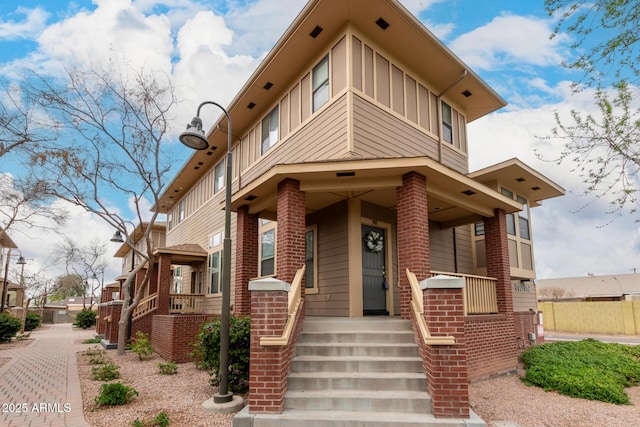 view of front of house featuring board and batten siding and brick siding