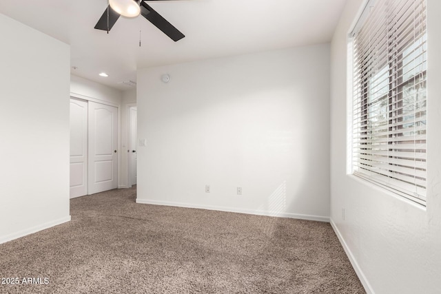 carpeted spare room featuring recessed lighting, baseboards, and a ceiling fan