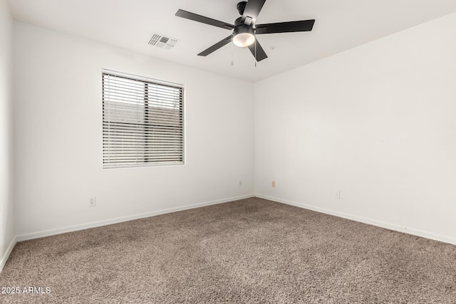 unfurnished room with visible vents, carpet flooring, baseboards, and a ceiling fan