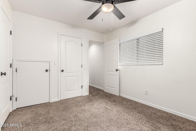 unfurnished bedroom featuring a ceiling fan, carpet, and baseboards