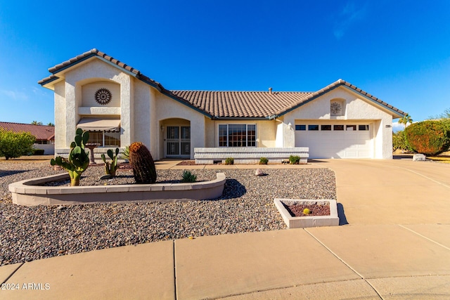 mediterranean / spanish-style home featuring a garage